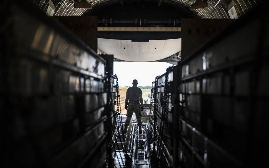 An airman loads weapons cargo bound for Ukraine onto a C-17 Globemaster III on Sept. 14, 2022, during a security assistance mission at Dover Air Force Base, Del.