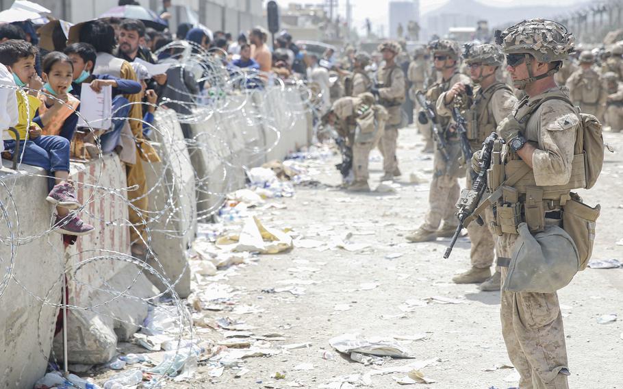 U.S. Marines provide assistance during an evacuation at Hamid Karzai International Airport in Kabul, Afghanistan, on Aug. 20, 2021. 