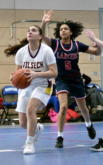 Vilseck’s Jade Hofeldt, left, prepares to go up for a drive against Lakenheath’s Alanah Melvin during pool play of the Division I DODEA European Basketball Championships on Wednesday at Ramstein High School on Ramstein Air Base, Germany.