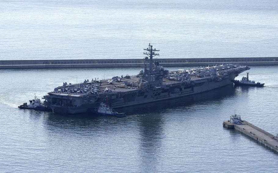 The USS Ronald Reagan is escorted as it arrives in Busan, South Korea on Sept. 23, 2022. 