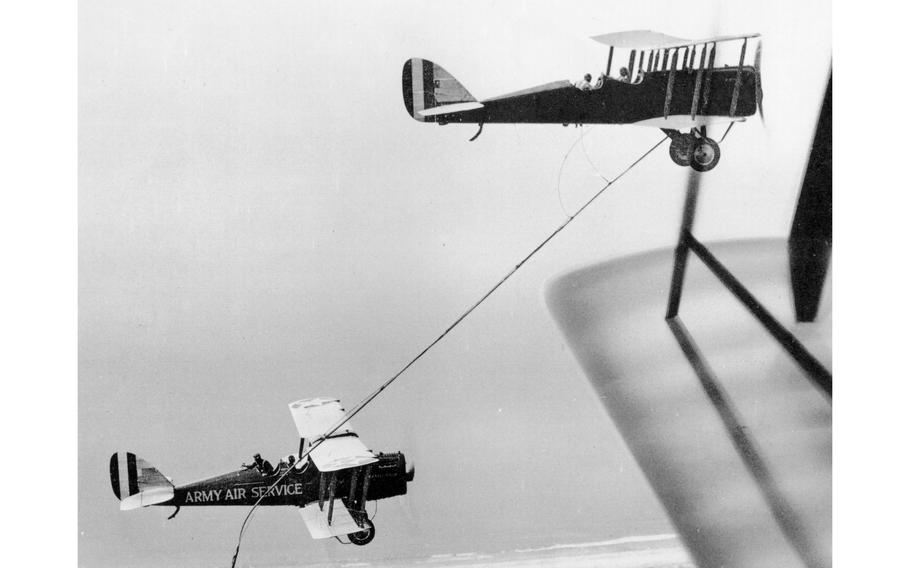 Two pilots with the Army Air Service pump fuel through a hose from one plane to another in the sky over San Diego on June 27, 1923. The Air Force will commemorate the event on Tuesday with flyovers in all 50 states.