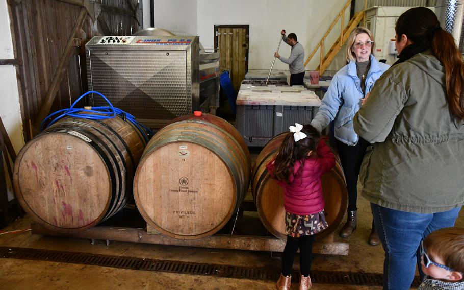 Linda Howard, the owner of Giffords Hall Vineyard, explains to the fermentation process in the vineyard barn. The English vineyard’s winemaker is hard at work in the background. 