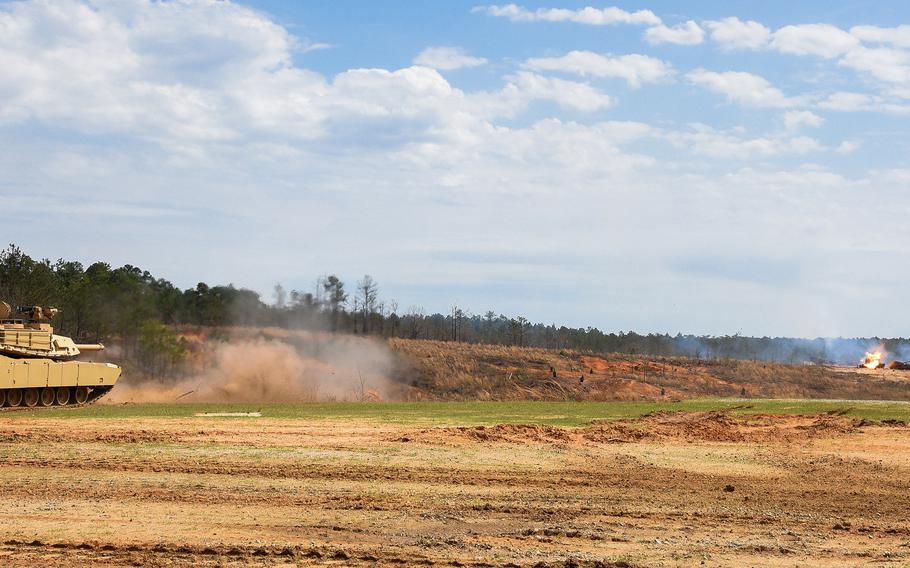 A U.S. Army M1A2 SEP V3 Abrams Main Battle Tank from the 316th Cavalry Brigade fires its main gun — a 120mm smoothbore cannon — and strikes a target downrange during a demonstration of combined armed tactics at Fort Benning, Ga., on March 24, 2022, during the African Land Forces Summit.