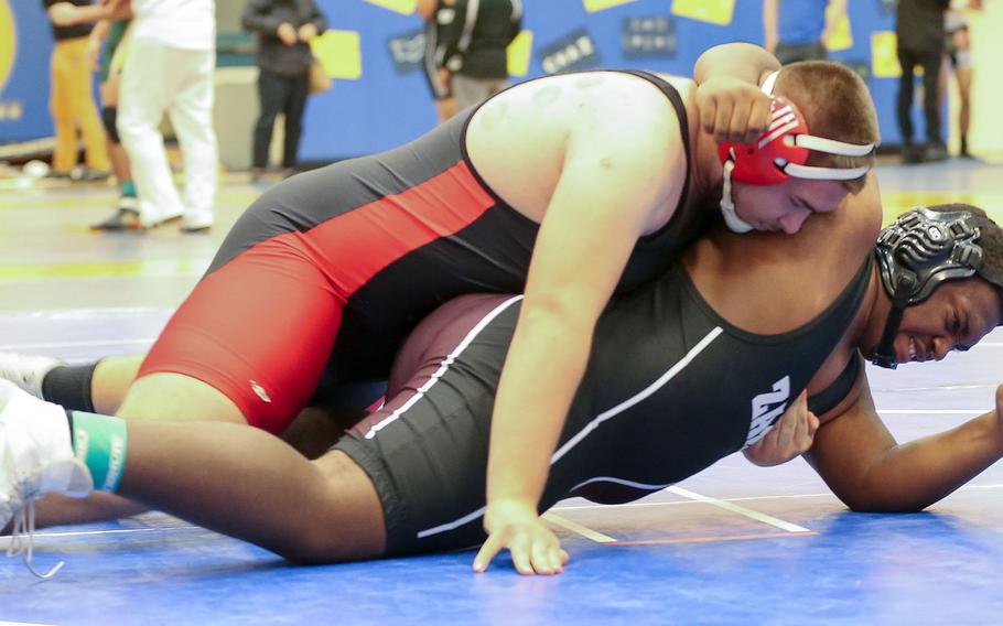 Nile C. Kinnick's Bobby Crisafulli gets the upper hand on Zama's Sean Neloms in the heavyweight final during Saturday's Yokota wrestling tournament.