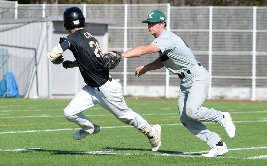 Kubasaki's Lukas Gaines tags out American School In Japan's Ryan Chon in a rundown during Friday's 14-7 Mustangs victory.