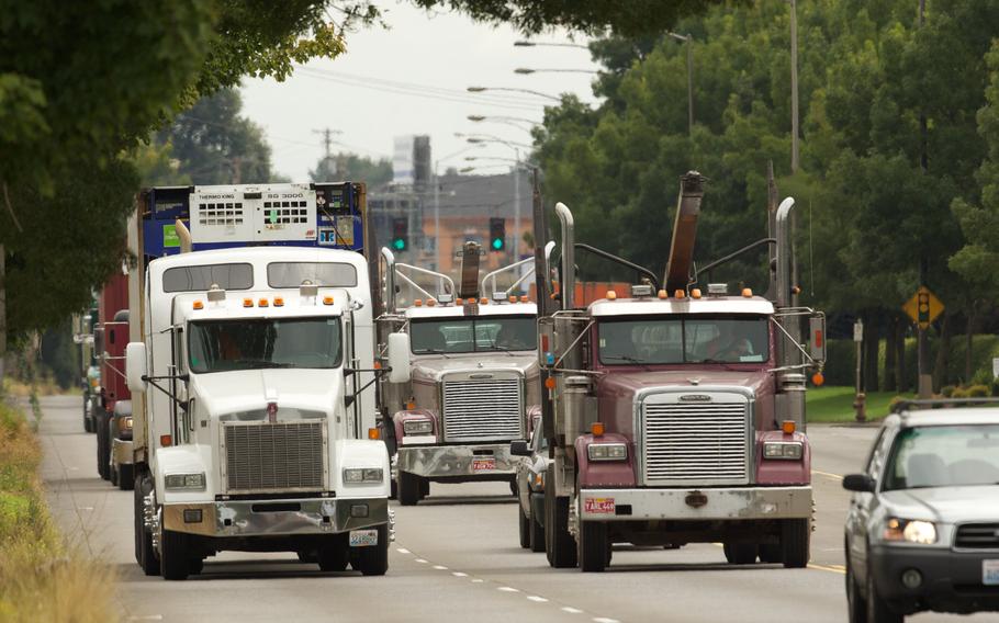 Trucks rolling down the road.