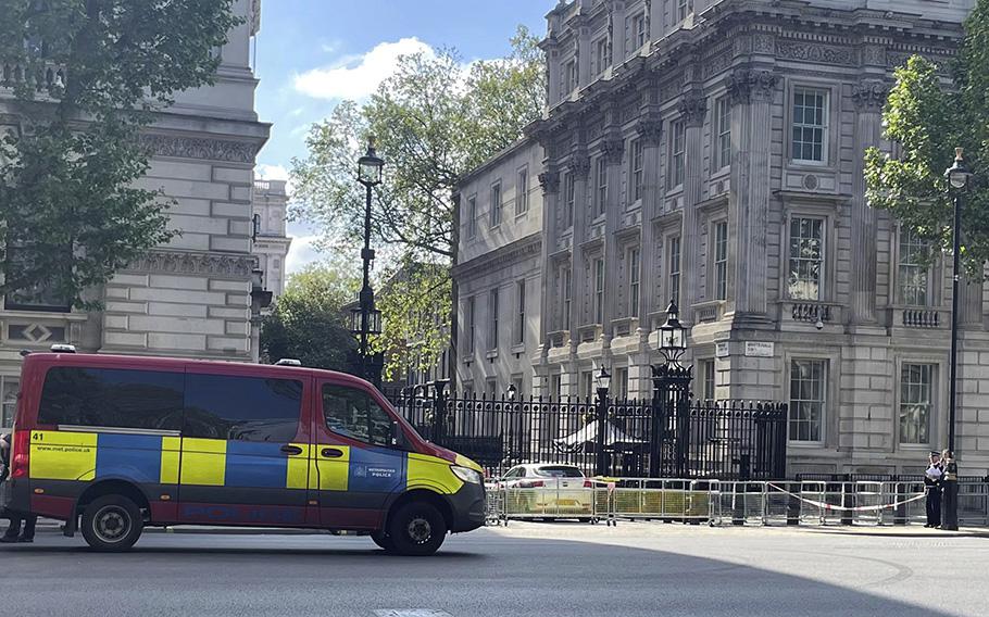 Police at the scene after a car collided with the gates of Downing Street, in London, Thursday May 25, 2023. 