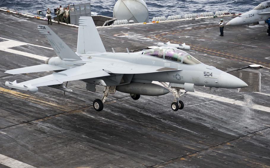 An EA-18G Growler assigned to the Electronic Attack Squadron (VAQ) 129 lands on the flight deck of the aircraft carrier USS Theodore Roosevelt (CVN 71).