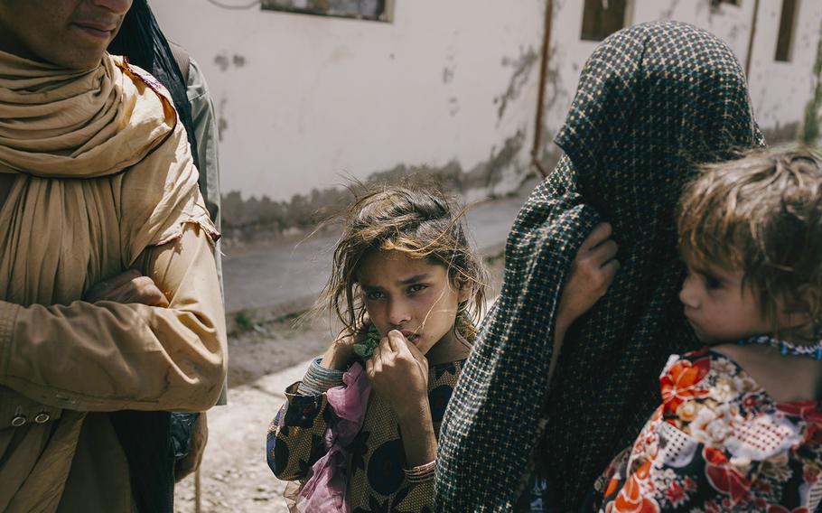 After pleading with Taliban guards to be allowed into the building, the woman and her two children were eventually turned away, in Marja, on June 13, 2022.