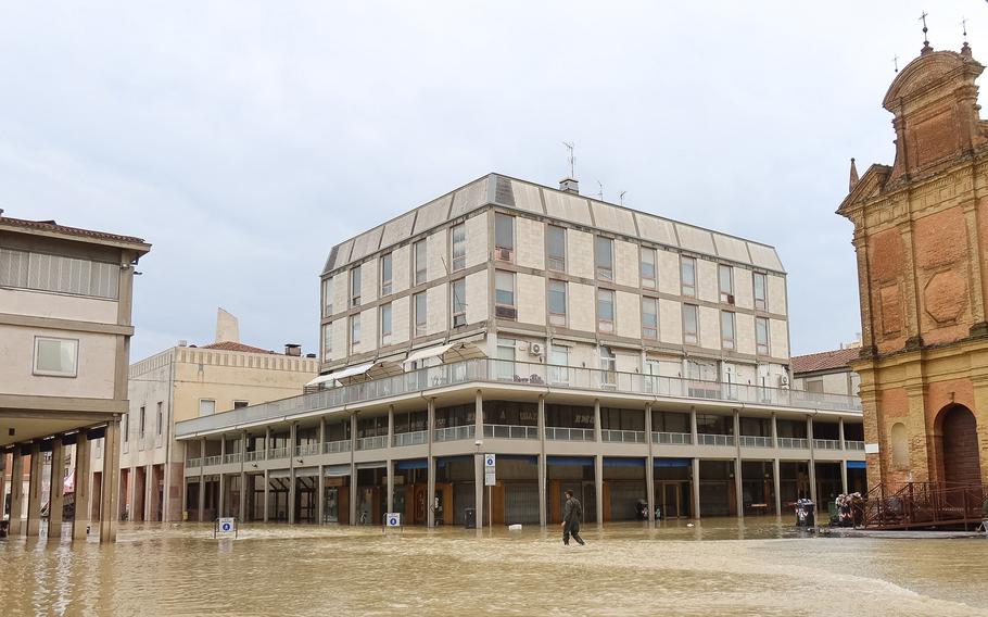 A resident walks across flooded streets in the town of Lugo on Thursday, May 18, 2023, after heavy rains caused flooding across Italy's northern Emilia Romagna region. Rescue workers searched on Thursday for people still trapped by floodwaters in northeast Italy as more residents were evacuated after downpours that killed nine people and devastated homes and farms.
