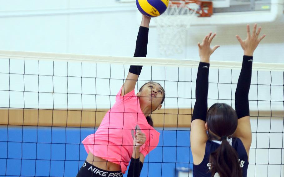 E.J. King's Mila Nishimura-Reed spikes against International School of the Sacred Heart's Sakurako Park during Tuesday's Far East Division II volleyball tournament pool play. The Cobras won in two sets.