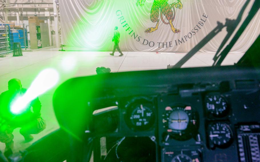 U.S. Air Force Master Sgt. Nathan Lipscomb points a laser at an HH-60 Pave Hawk during a demonstration at Aviano Air Base, Italy, Oct. 12, 2023. Laser strikes on aircraft are extremely dangerous to pilots and crew members, and are illegal in most countries.