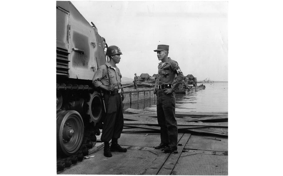 PFC Bobby Rutherford of the 8224th Military Police Detachment harbor patrol chats with a Korean security guard on the docks of Incheon Harbor.