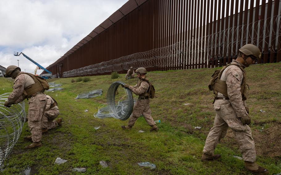 Marines add concertina wire to the U.S.-Mexico border walls.