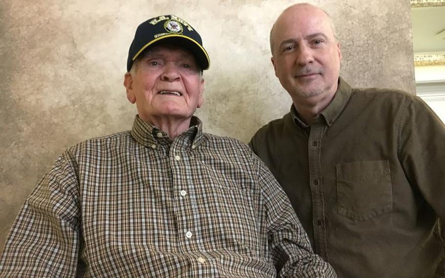 World War II veteran Russell Brakefield, left, shares a smile with photographer Jeffrey Rease, right, during a break in a portrait session. Brakefield, 93, died on July 2, 2021.