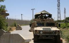 Afghan National Army (ANA) soldiers stand guard at a road checkpoint outside Bagram Air Base, after all US and NATO troops left, some 70 Km north of Kabul on July 2, 2021. (Zakeria Hashimi/AFP via Getty Images/TNS)