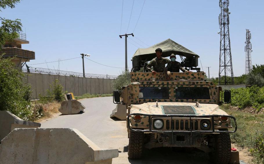 Afghan National Army soldiers stand guard at a road checkpoint outside Bagram Airfield, after all US and NATO troops left, on July 2, 2021. 