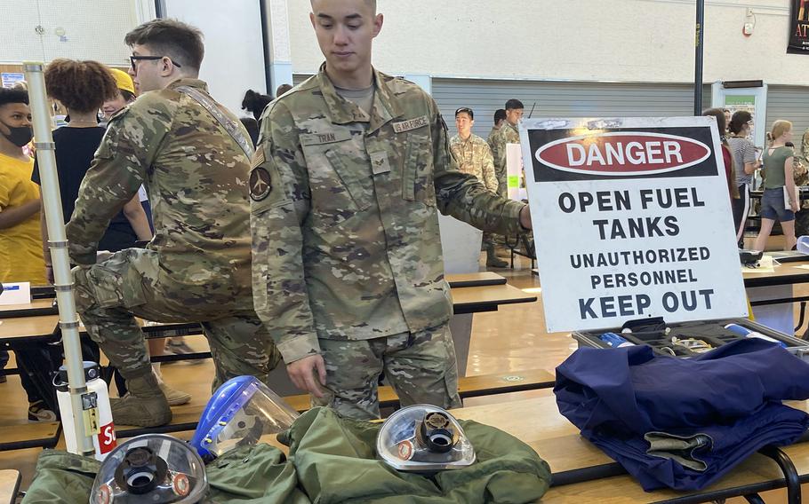 Senior Airman Steven Tran displays items from the 374th Maintenance Squadron's aircraft fuel systems during Career Day at Yokota Middle School on Yokota Air Base, Japan, Thursday, May 5, 2022. 