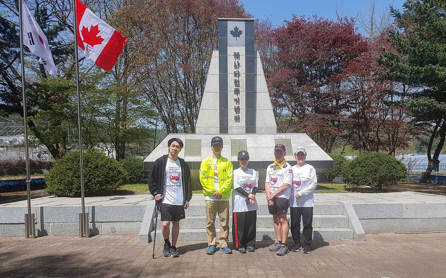 Guy Black poses with family members at the Canadian Korean War Memorial Garden in Gapyeong, South Korea, April 21, 2023. 