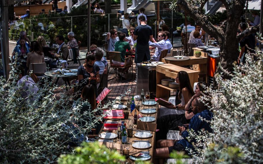 Customers on a restaurant terrace on Barceloneta promenade in Barcelona, Spain, on June 5, 2021. 