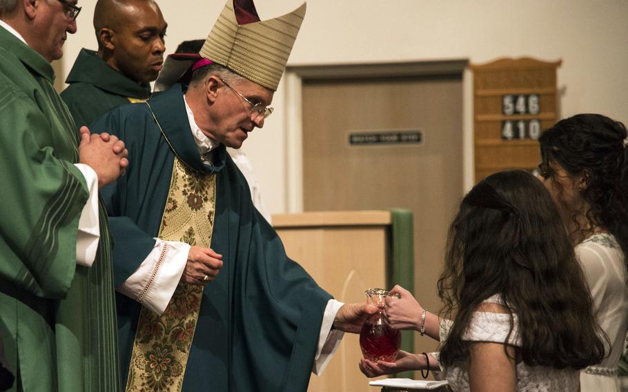 Timothy P. Broglio, archbishop for the military services, receives wine for communion at MacDill Chapel in Tampa, Fla., in 2019. Catholics in the U.S. military have the right to refuse the coronavirus vaccination if they have a conscientious objection to the inoculation, Broglio said in a statement Oct. 12, 2021.