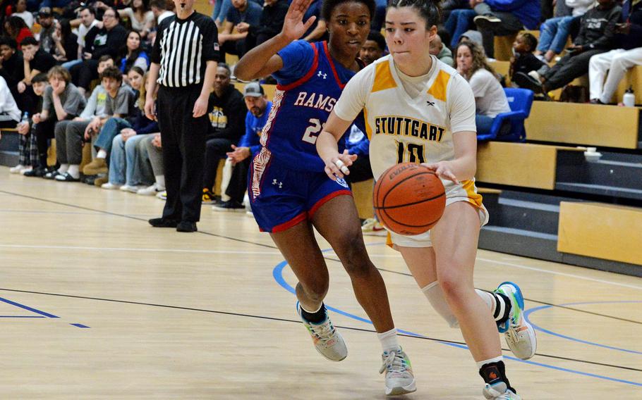 Stuttgart’s Mia Snyder drives to the basket against Ramstein’s Bralyn Jones in the girls Division I final at the DODEA-Europe basketball championships in Wiesbaden, Germany, Feb. 17, 2024. Stuttgart beat the Royals 33-26 to take the DI crown.