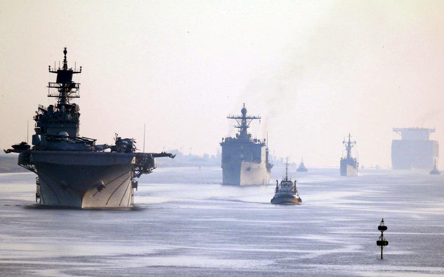 Amphibious assault ship USS Iwo Jima, left, and dock landing ship USS Carter Hall transit the Suez Canal in formation, June 1, 2021. 