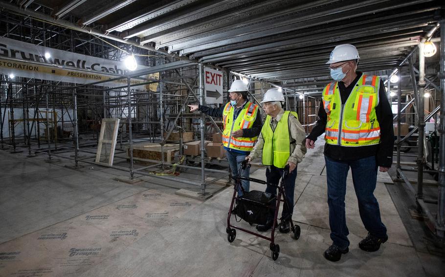 Michigan Central construction manager Richard Bardelli, left, and project manager Gary Marshall, right, guide George England for a tour inside Michigan Central Station in Detroit on Sept. 25, 2021.