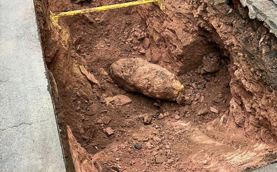 A 550-pound World War II bomb found during excavation work awaits an ordnance disposal team in Kaiserslautern, Germany, Feb. 17, 2023. An area with about 3,400 residents was evacuated for more than eight hours before the bomb was defused and removed.