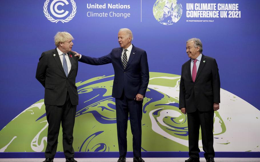 British Prime Minister Boris Johnson, left, and UN Secretary-General Antonio Guterres, right, greet U.S. President Joe Biden, at the COP26 U.N. Climate Summit in Glasgow, Scotland, Monday, Nov. 1, 2021. 