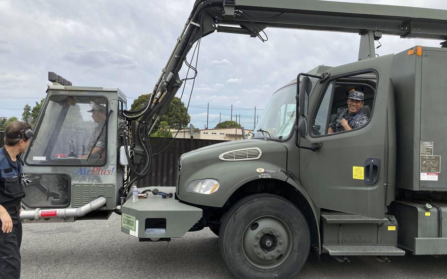 Japanese airmen familiarize themselves with a vehicle used to remove ice from aircraft at Yokota Air Base, Japan, Thursday, Sept. 7, 2023. 