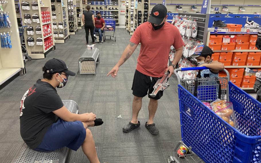 Staff Sgt. Eddie Hernandez used his $1,000 gift card to buy his boys tennis shoes at Academy Sports + Outdoors store Tuesday.