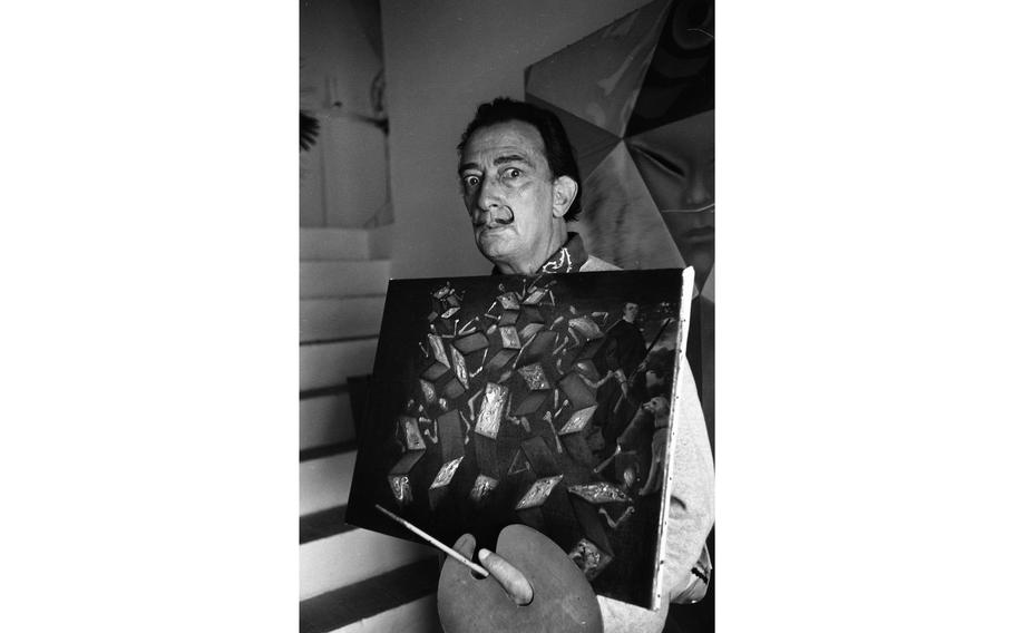 Salvador Dali holds one of his works titled “Twist in Velásquez’s Studio.” “Zeeze are ghosts doing zee tweest en zee studio of Velazquez,” the surrealist painter explained. The idea is that you look at it while playing “twist” music and flick the lights off and on — making the figures dance on canvas.