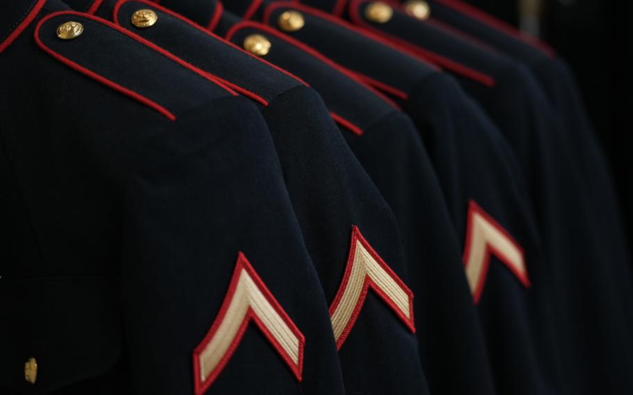 Marine Corps dress blue uniforms hang on a rack during the first uniform fitting at Marine Corps Recruit Depot San Diego on March 21, 2023.