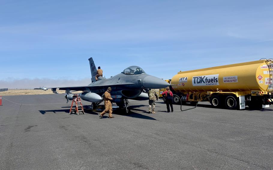 Air Force mechanics work on an F-16 Fighting Falcon.