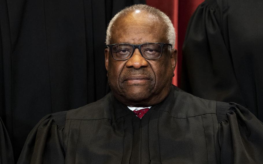 Associate Justice Clarence Thomas sits during a group photo of the justices at the Supreme Court in Washington, D.C., on April 23, 2021. 
