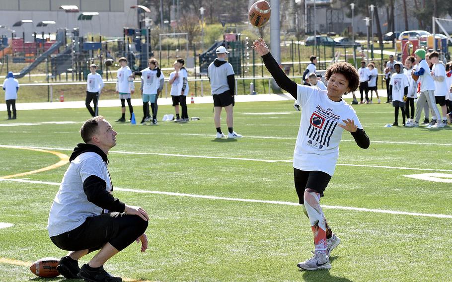 Jaleea Williams, 10, throws a pass during the Matthew Judon Football ProCamp on March 23, 2024, at Kaiserslautern High School in Kaiserslautern, Germany.