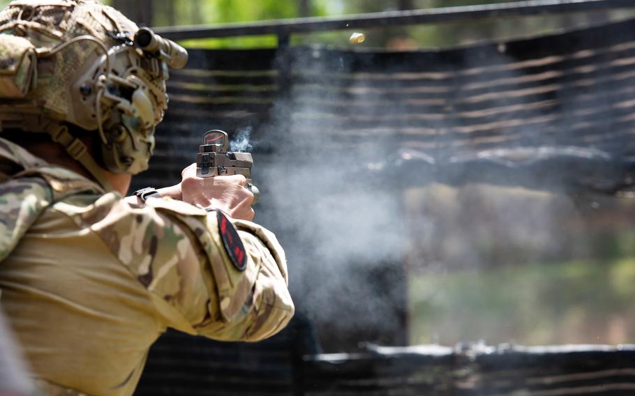 A soldier fires a pistol during the International Sniper Competition at Fort Benning, Ga., on Tuesday, April 11, 2023. 