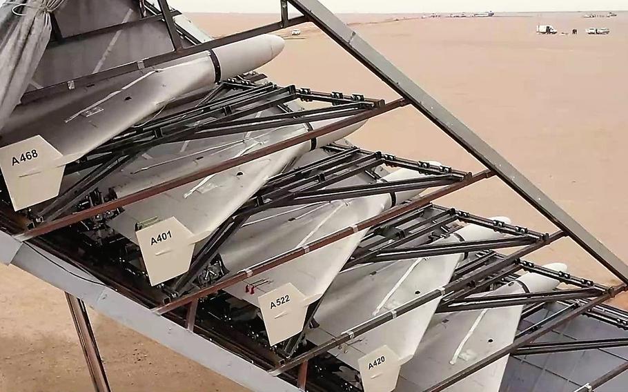 Military drones are stored in a transport container.
