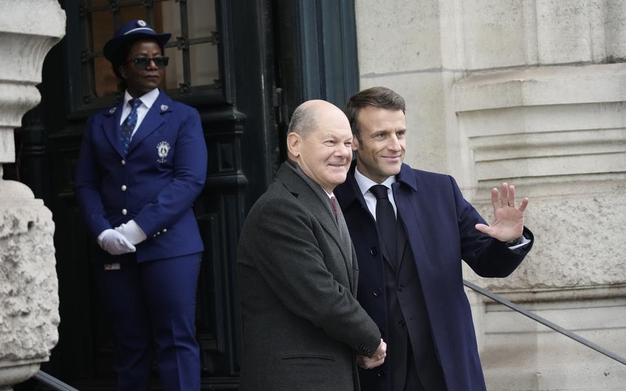 French President Emmanuel Macron, right, welcomes German Chancellor Olaf Scholz outside the Sorbonne University before a ceremony to mark 60 years since a landmark treaty sealed a bond between the longtime enemies, Sunday, Jan. 22, 2023, in Paris. France and Germany are seeking to overcome differences laid bare by Russia’s war in Ukraine and shore up their alliance with a day of ceremonies and talks Sunday on Europe’s security, energy and other challenges.