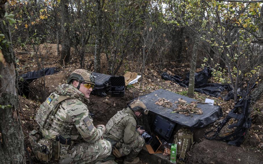 Ukrainian Maj. Volodymyr Voloshyn watches a military drone operator, Arthur, as he communicates with an artillery brigade to direct their fire in the Mykolaiv region in southern Ukraine on Oct. 5.