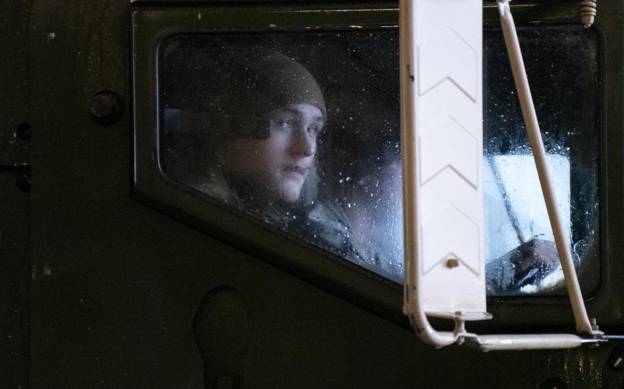 A Marine looks out the window of a logistics vehicle during a rainy day at Setermoen Military Camp, Norway, on Saturday, March 19, 2022.