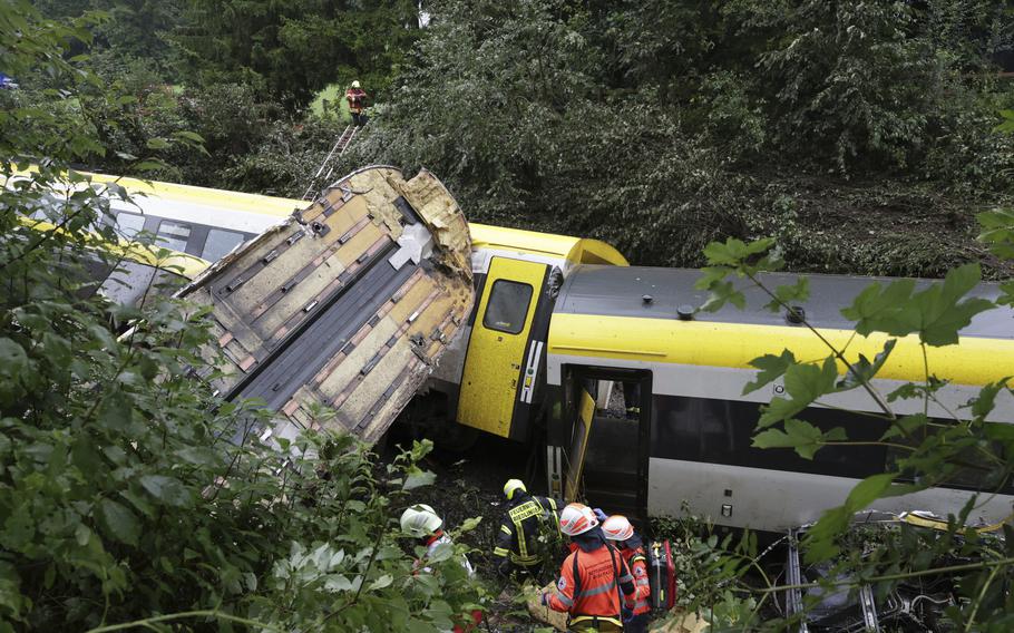 Rescue workers search for passengers in the crumpled train.