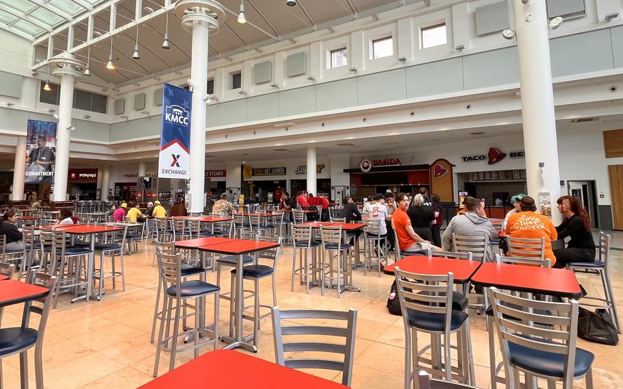 Workers sit in a food court.