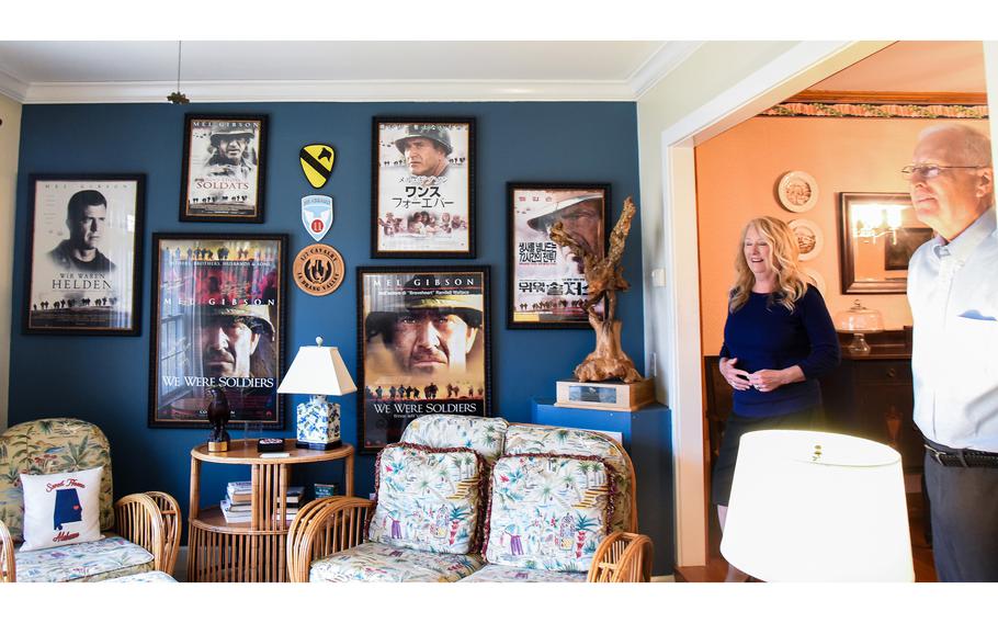 Steve Moore and his sister Cecile Moore Rainey look on near movie posters for “We Were Soldiers” and other memorabilia from their father Lt. Gen. Hal Moore’s service at the Moore family home in Auburn, Ala. on Friday, Feb. 17, 2023. Fort Benning, Ga., will be renamed in honor of Hal Moore and his wife Julia later in 2023.