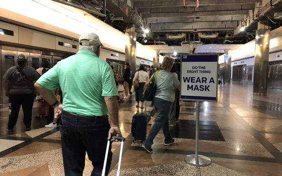 Air travelers head to departure gates at Denver International Airport in Colorado on June 6, 2021. Germany tightened coronavirus restrictions in mid-August for travelers from the United States, where the delta variant has pushed new infections back up to nearly 129,000 a day.