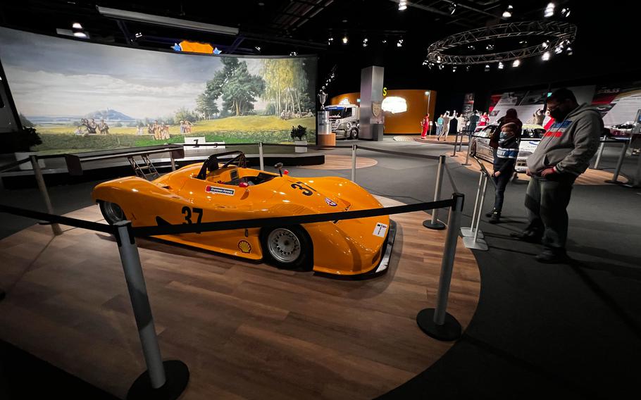 Visitors to the Nuerburgring's Ringwerk museum look at a 1993 Alpha Romeo Argo JM 21 in Nuerburg, Germany, Jan. 15, 2022. Alpha Romeo only built five vehicles of this type, which were used to in the European Interseries race championship.