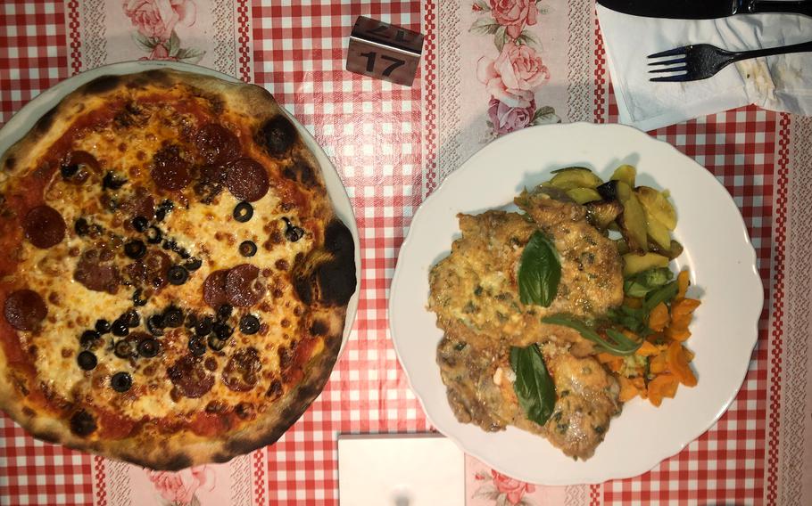 A meal of pork cutlet and pizza served at Trattoria Da Balbi in Wiesbaden, Germany.