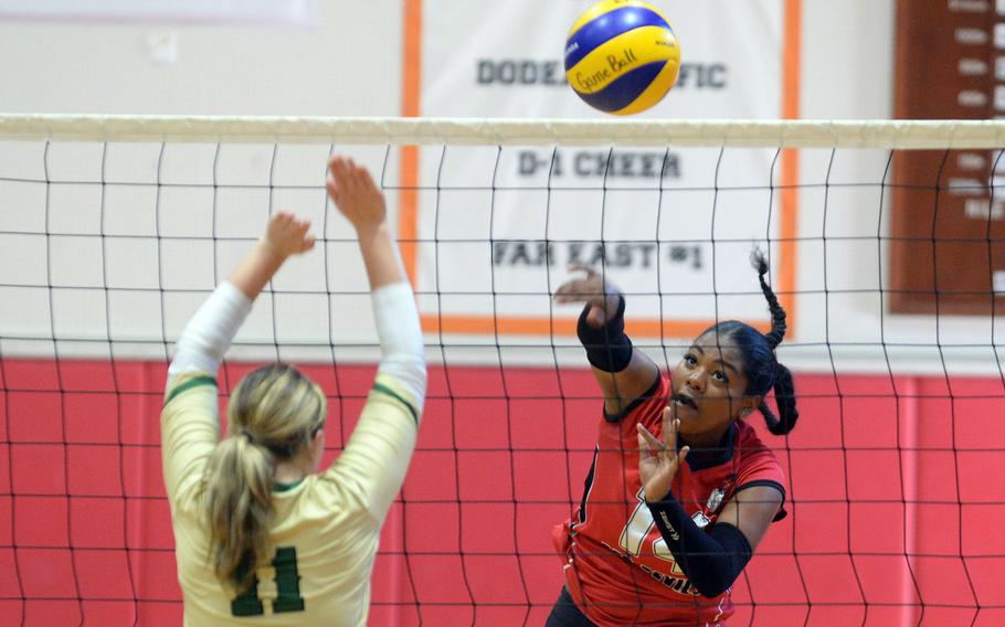 Nile C. Kinnick's Michele Holloway spikes against Robert D. Edgren's Summer Martinez during the Red Devils' two-set DODEA-Japan victory Saturday.