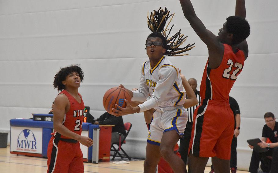 Wiesbaden’s Jordan Thibodeaux drives for a shot against Kaiserslautern’s Uray Dukuly in the last day of pool play at the DODEA European Division I Basketball Championships on Thursday, Feb. 15, 2024, in Wiesbaden, Germany.